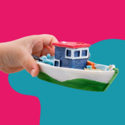 Child holding a toy boat